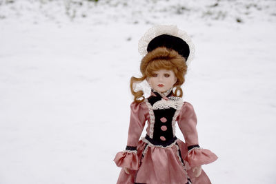 Full length of woman standing on snow covered land