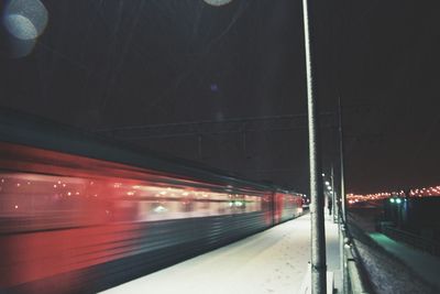 Blurred motion of train on road at night