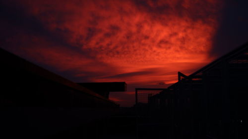 Low angle view of silhouette buildings against sky during sunset