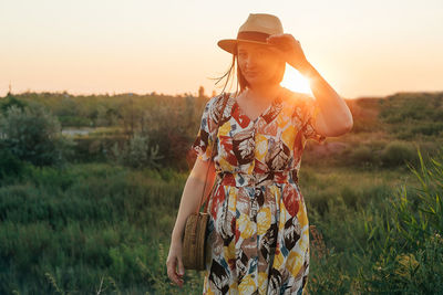 Side view of woman standing on field