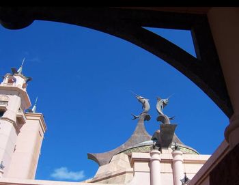 Low angle view of statue against blue sky