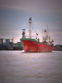 Ship in sea at sunset