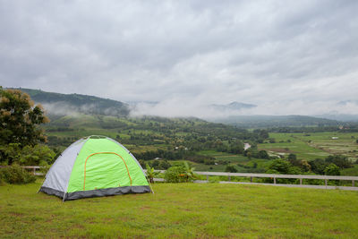 Tent on field against sky