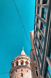 Low angle view of buildings against clear blue sky