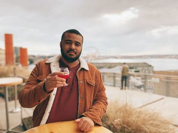 Portrait of a young man drinking drink