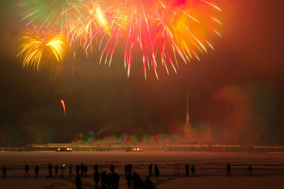 Firework display over sea at night