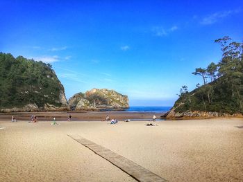 Scenic view of beach against blue sky