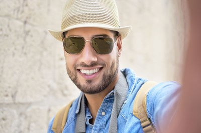 Portrait of smiling young man wearing sunglasses