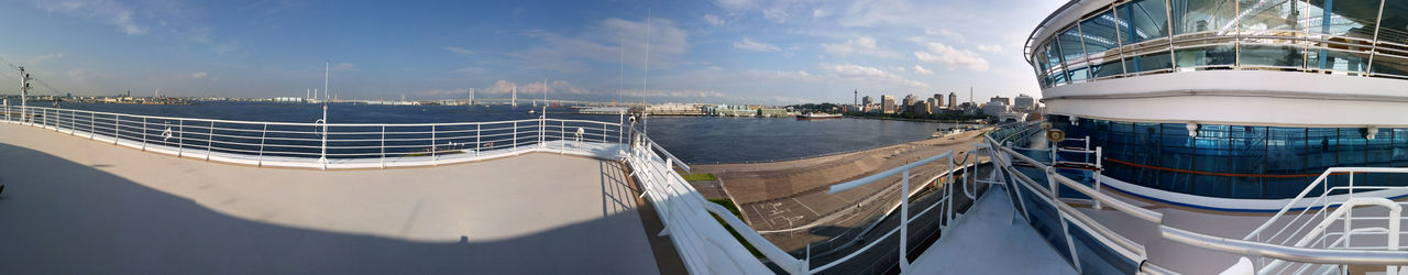 Panoramic view of sea and buildings against sky