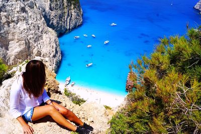 High angle view of woman sitting on beach