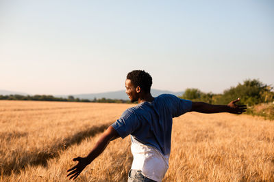 Rear view of man standing on field