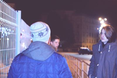 People on illuminated city at night