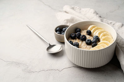 Porridge with bananas and blueberries for healthy breakfast or lunch. natural ingredients