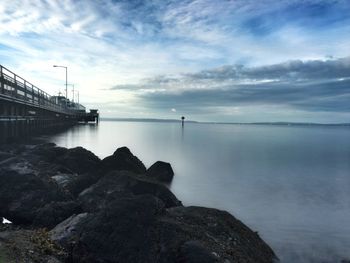 Scenic view of sea against cloudy sky