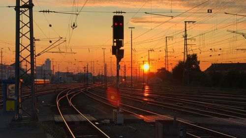 Railroad tracks against sky during sunset