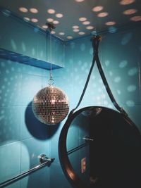 Disco ball hanging by mirror