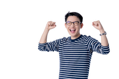 Portrait of smiling man standing against white background