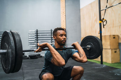 Full length of man exercising in gym