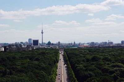 View of cityscape against cloudy sky