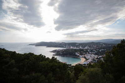 High angle view of sea and trees against sky