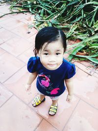 Portrait of girl sitting on plant