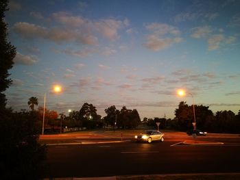 Cars on road at sunset