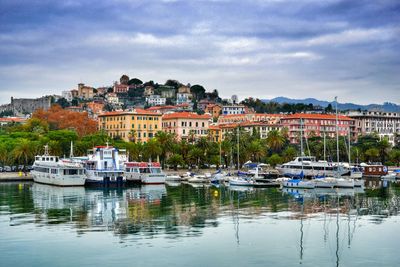 Boats in harbor with buildings in background