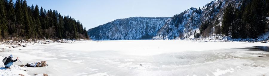 Scenic view of snow covered mountains against sky during winter