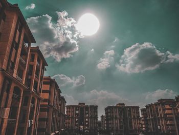 Low angle view of buildings against sky on sunny day