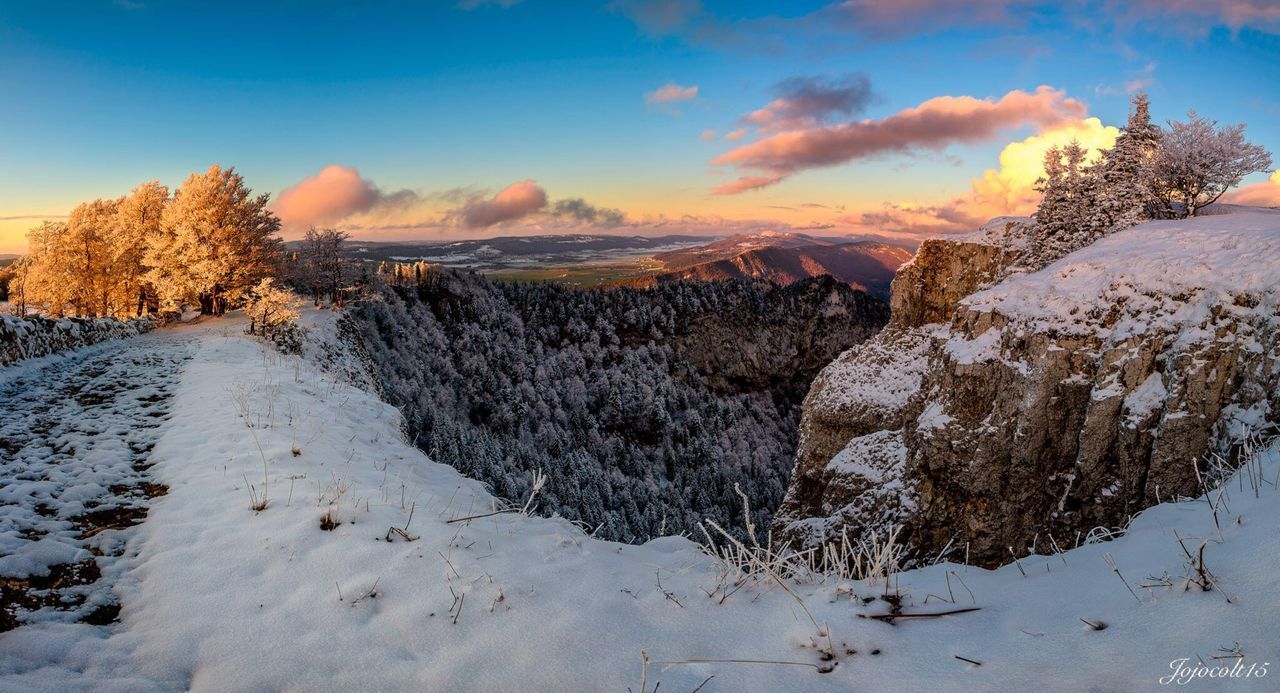 SNOW COVERED LAND DURING SUNSET