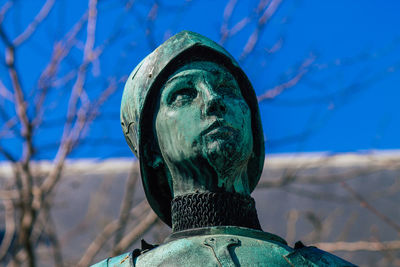 Close-up of statue against blue sky
