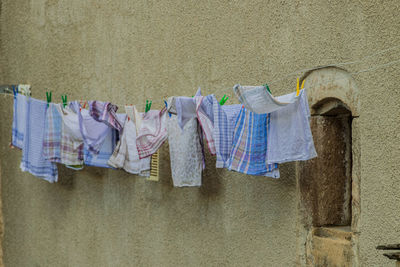 Close-up of clothes drying against wall