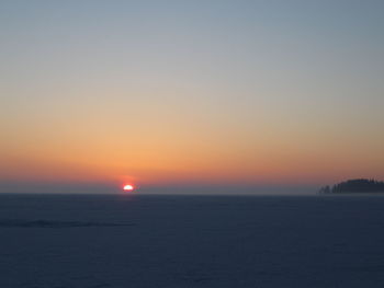 Scenic view of sea against clear sky during sunset