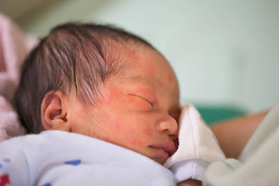 Close-up high angle view of baby boy sleeping