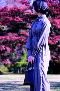 Side view of woman standing at park