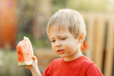 Close-up portrait of boy holding food