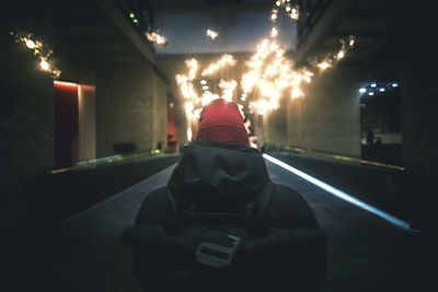 Rear view of men at night