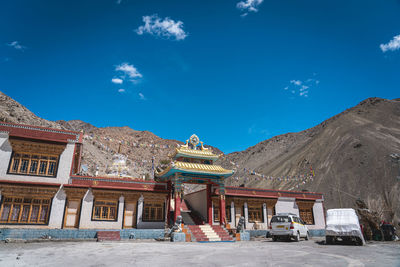 Low angle view of built structures against blue sky