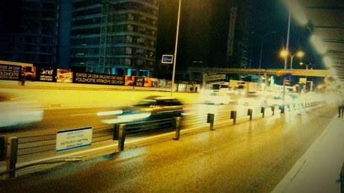 Cars moving on city street at night