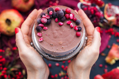 Midsection of person holding cake