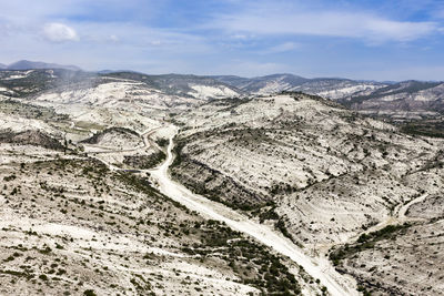 High angle view of mountain road against cloudy sky