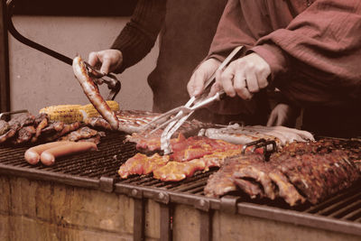 Man preparing food on barbecue grill