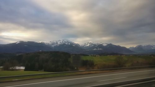 Scenic view of mountains against cloudy sky