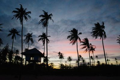 Silhouette palm trees against sky during sunset