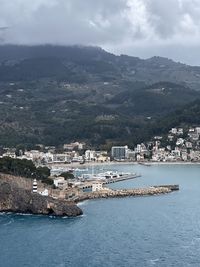 High angle view of townscape by sea against sky