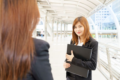 Portrait of a young woman using phone