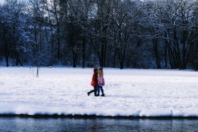 Rear view of woman on snow covered land