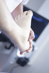 Close-up of hand holding feet