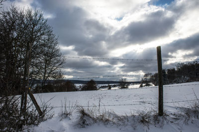Snow covered landscape against sky