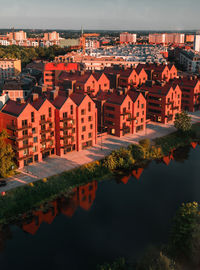 High angle view of river by houses against sky